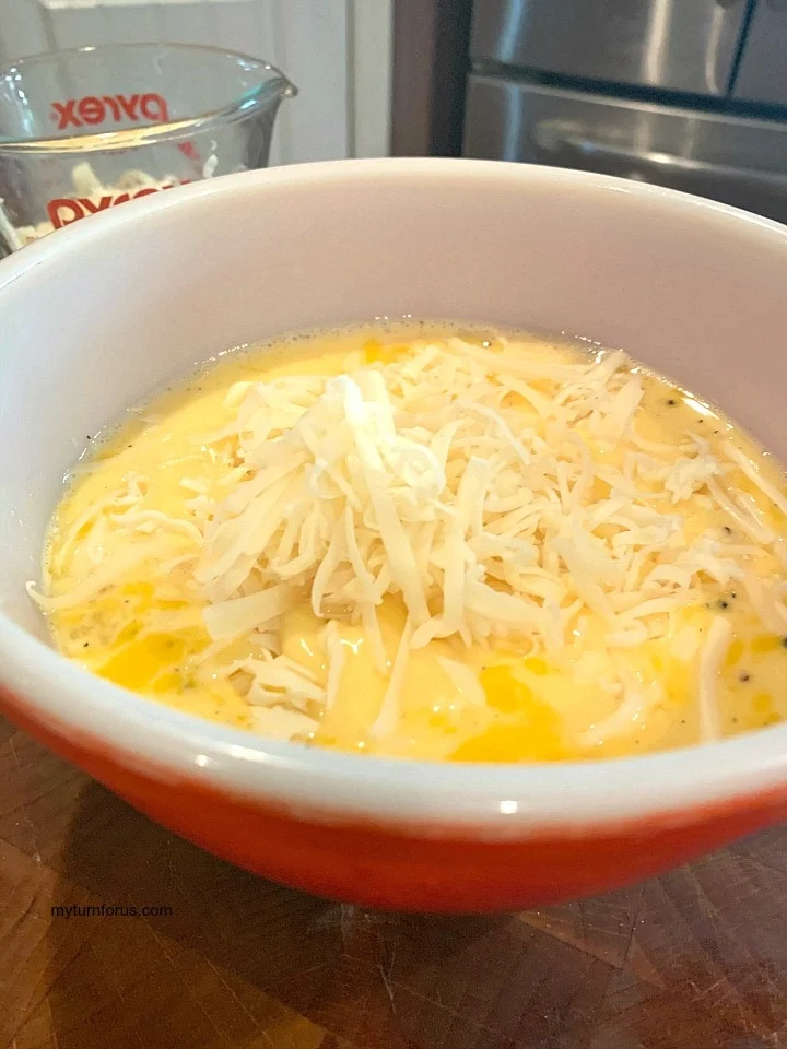 adding cheese to the egg mixture
