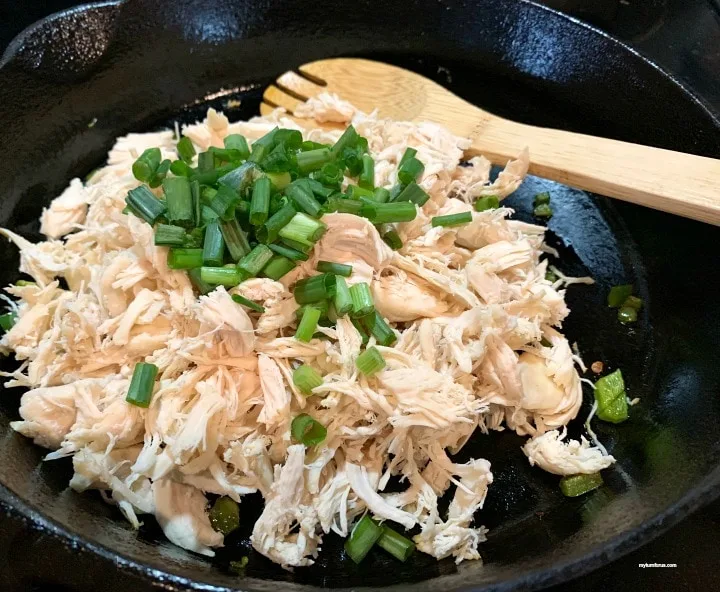 chicken breast and onions cooking in skillet