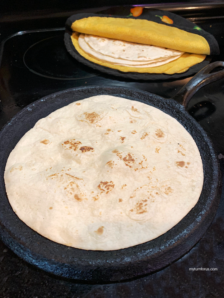 Heating tortillas on a comal
