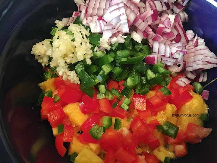 adding garlic and vinegar to the chopped veggies