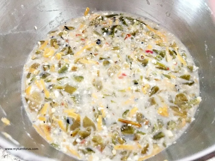 mixing bread with cheese and chilies