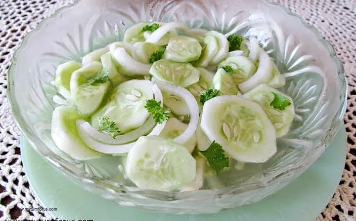 cucumbers in vinegar, sliced cucumbers and onions served in a bowl