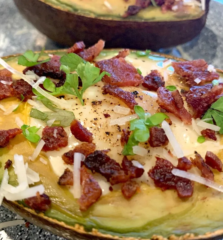 egg boats, avocado halves filled with egg and baked, topped with bacon pieces