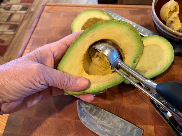 cutting avocados, scooping out avocados