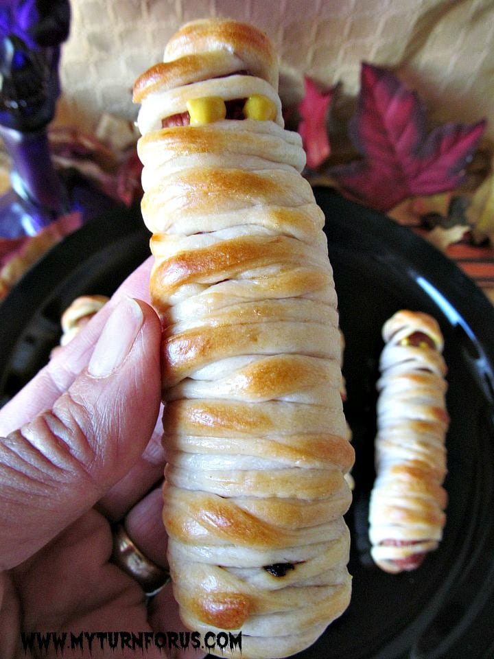 mummy hot dogs, ghoulish halloween treats, hot dogs wrapped in pizza dough, 