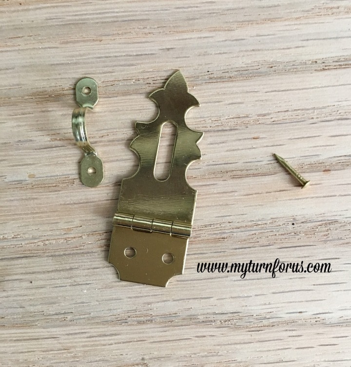 Horseshoe Fairy Door for the most magical fairy garden! https://www.myturnforus.com/2016/03/horseshoe-fairy-door.html Close-up of a decorative brass hasp, small metal loop, and nail used for the fairy door hardware.
