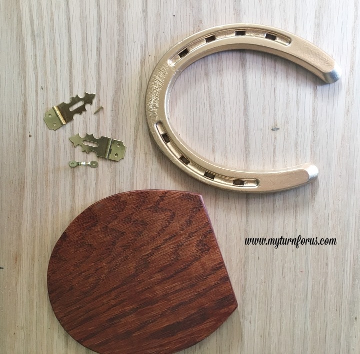 Horseshoe Fairy Door for the most magical fairy garden! https://www.myturnforus.com/2016/03/horseshoe-fairy-door.html Stained plywood door with a gold horseshoe, decorative hasps, nails, and metal loop ready for assembly.