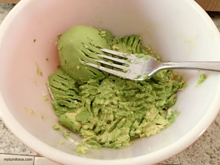 mashing avocado