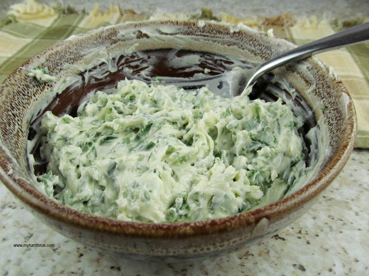 Mixing the herbs into the herb butter