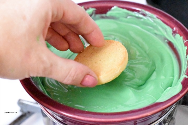 dipping cookie in melted candy for st patricks day snacks for kids ookies hats