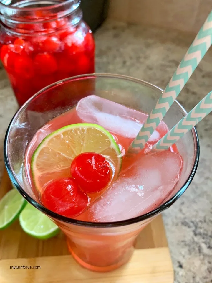 grownup cherry limeade, cherries, slices of lime with a vodka cherry limeade 