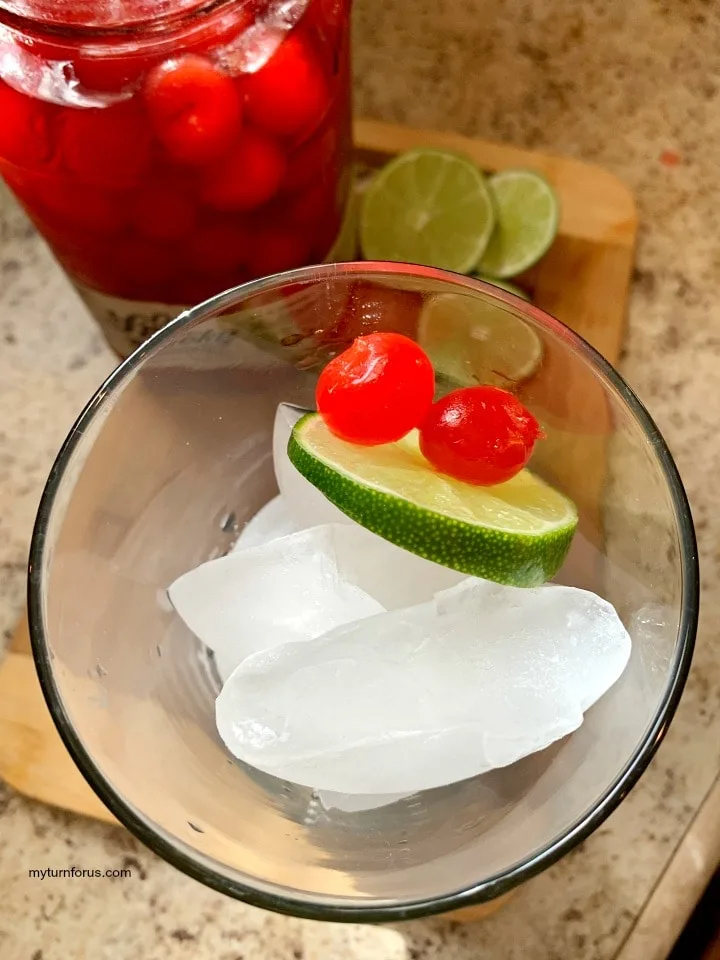 spiked cherry limeade, moonshine cherries with a slice of lime for an adult cherry limeade