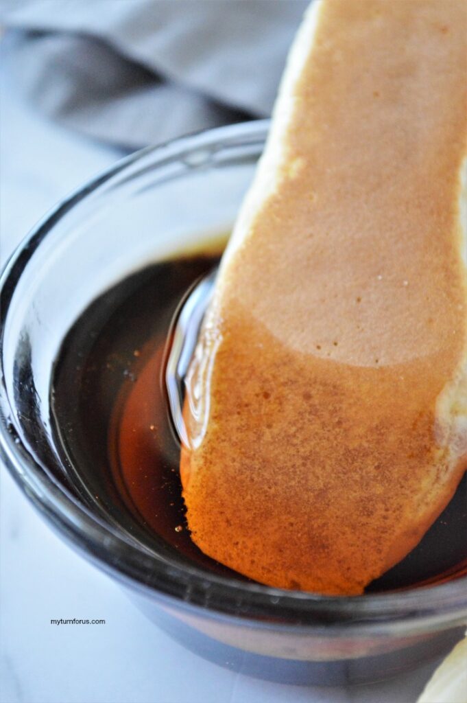 Banana Pancake Dippers dipped in maple syrup