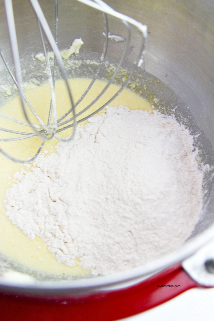 adding flour to the bread batter
