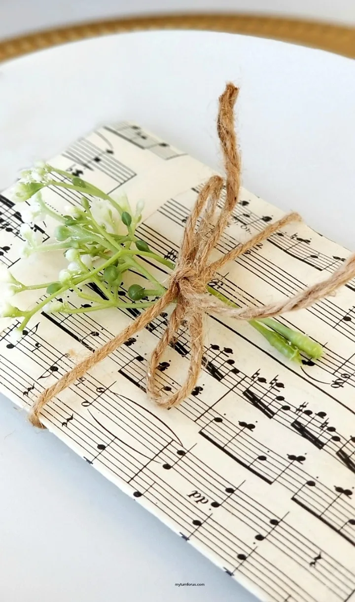 Music paper cutlery pouches tied with jute and with added greenery