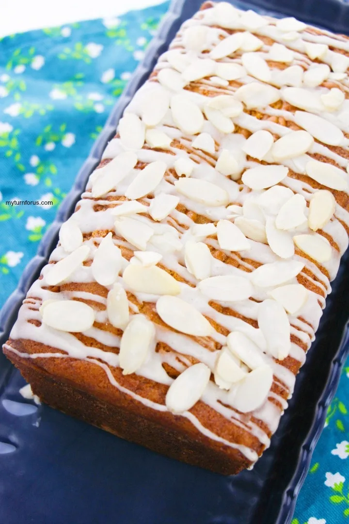 a loaf holiday eggnog bread with rum glaze and sliced almonds