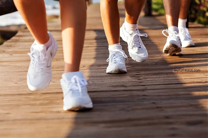 3 pairs of tennis shoes depicts walking a mile a day benefits