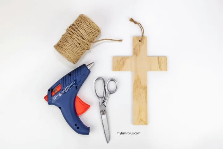 hot glue gun, jute, wooden cross and scissors 