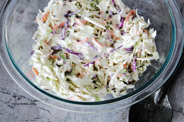 Homemade coleslaw dressing mixed into cabbage and carrots
