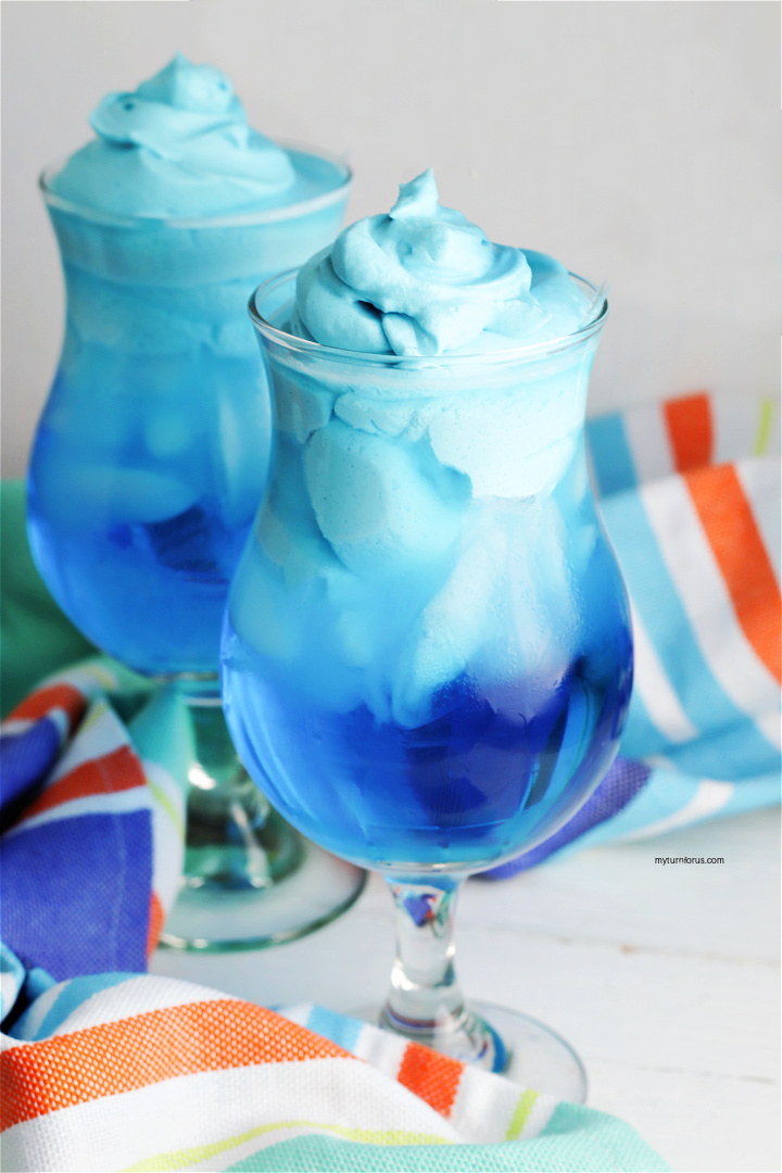blue kool-aid whipped drink in a glass
