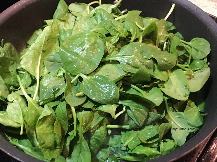 cooking spinach in skillet