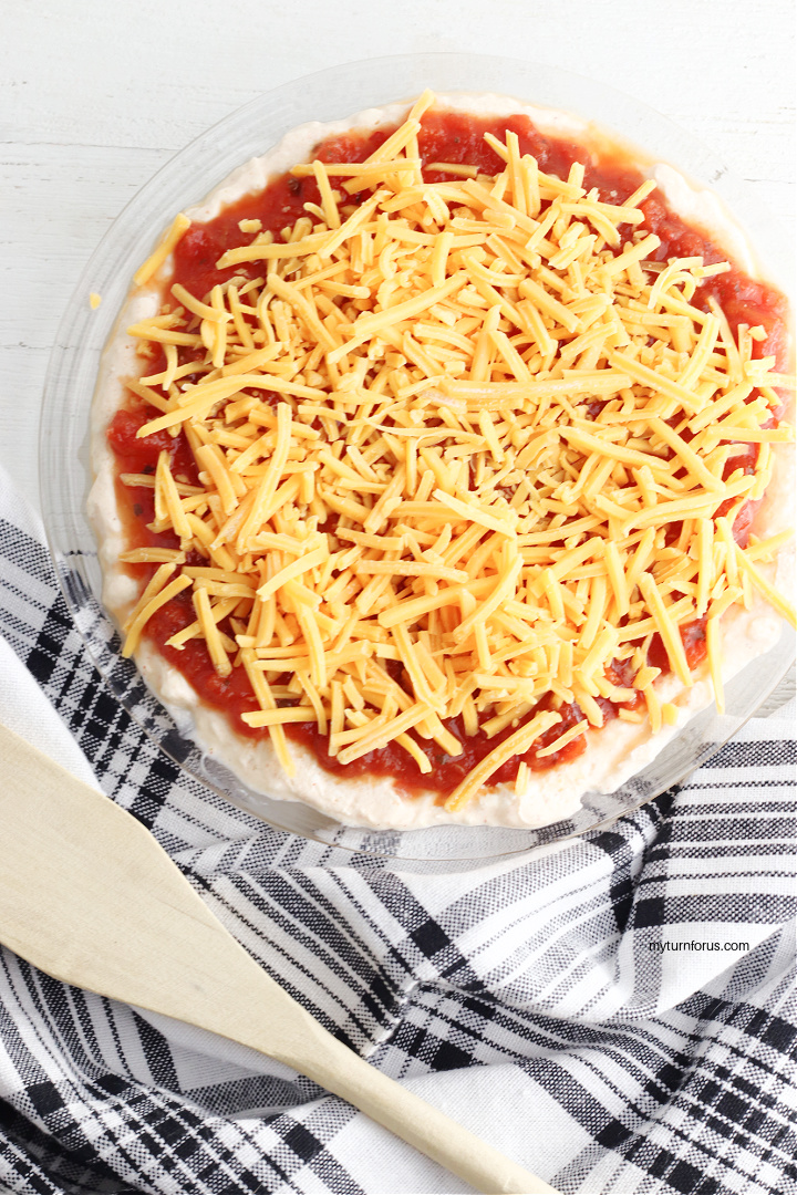 taco dip topped with shredded cheese