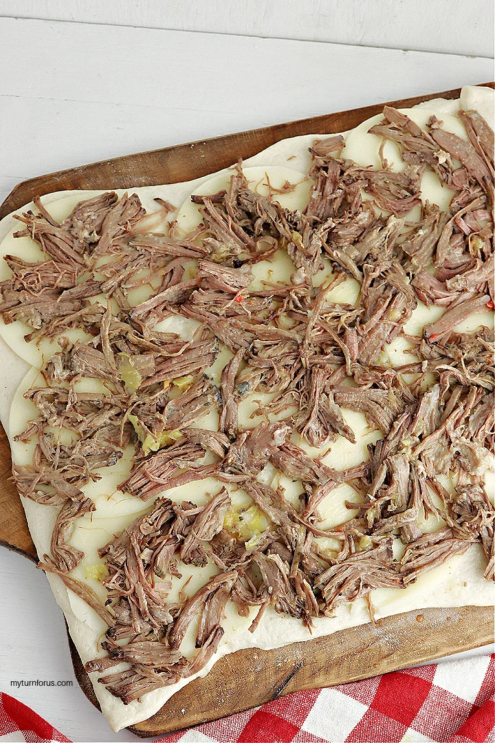 shredded beef on pizza dough