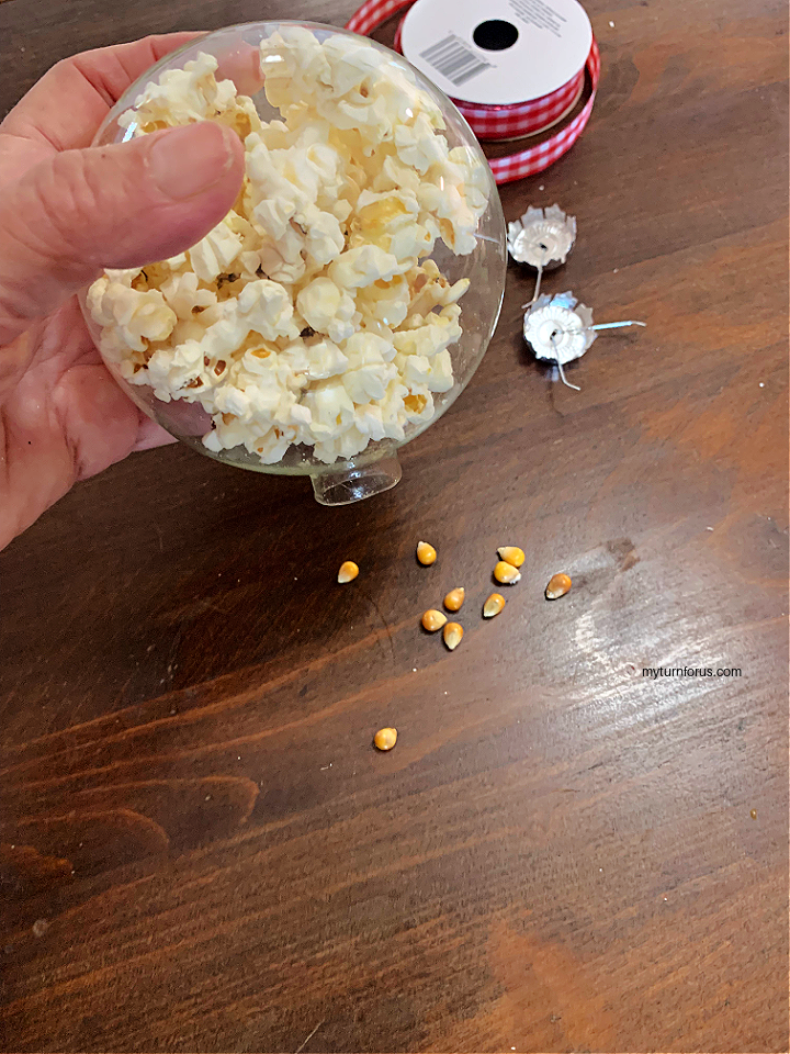 shaking unpopped corn from popcorn ornament
