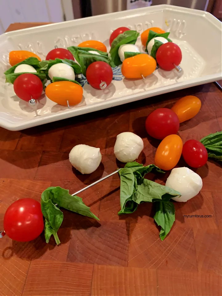 making tomato and bocconcini skewers