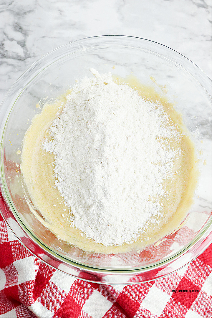 adding dry ingredients to the cake batter