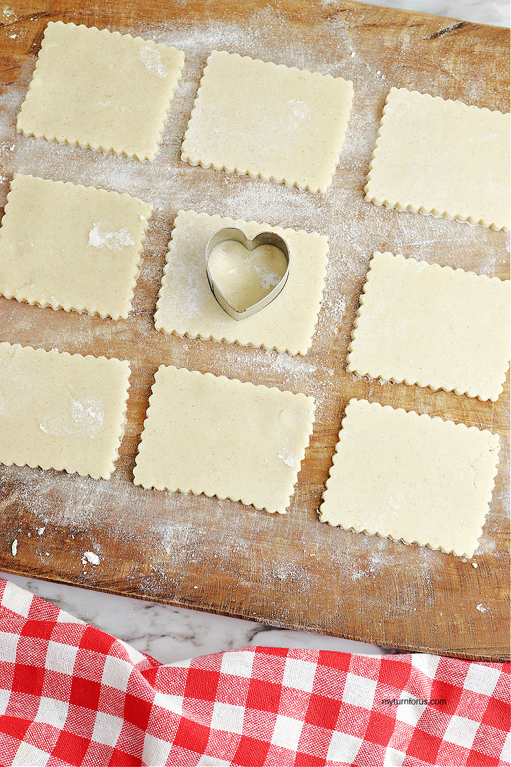 Cutting out heart linzer cookies